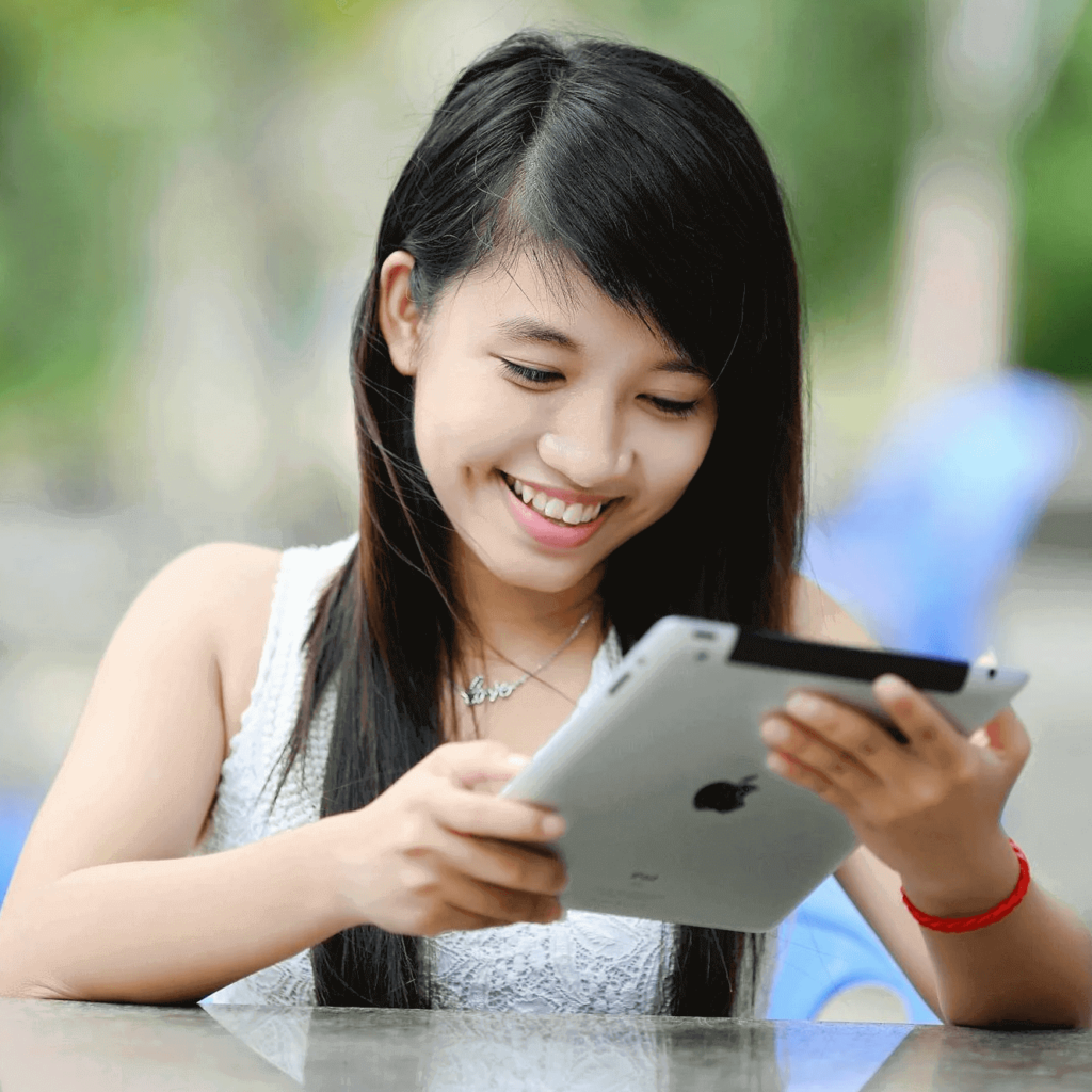 Happy girl holding iPad